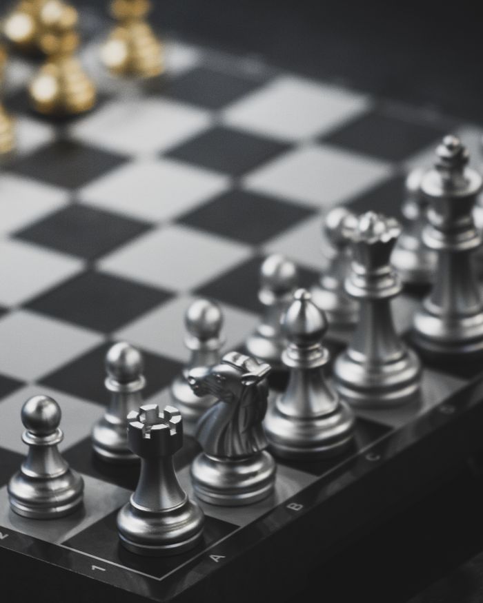 services-03 Close-up of a chess set with metal pieces ready for strategic gameplay.