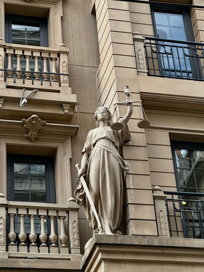 Statue of Justice on a classic building facade in Istanbul, Turkey.